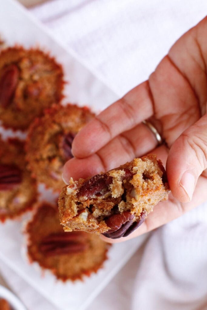 Inside of a muffin filled with pecan nuts