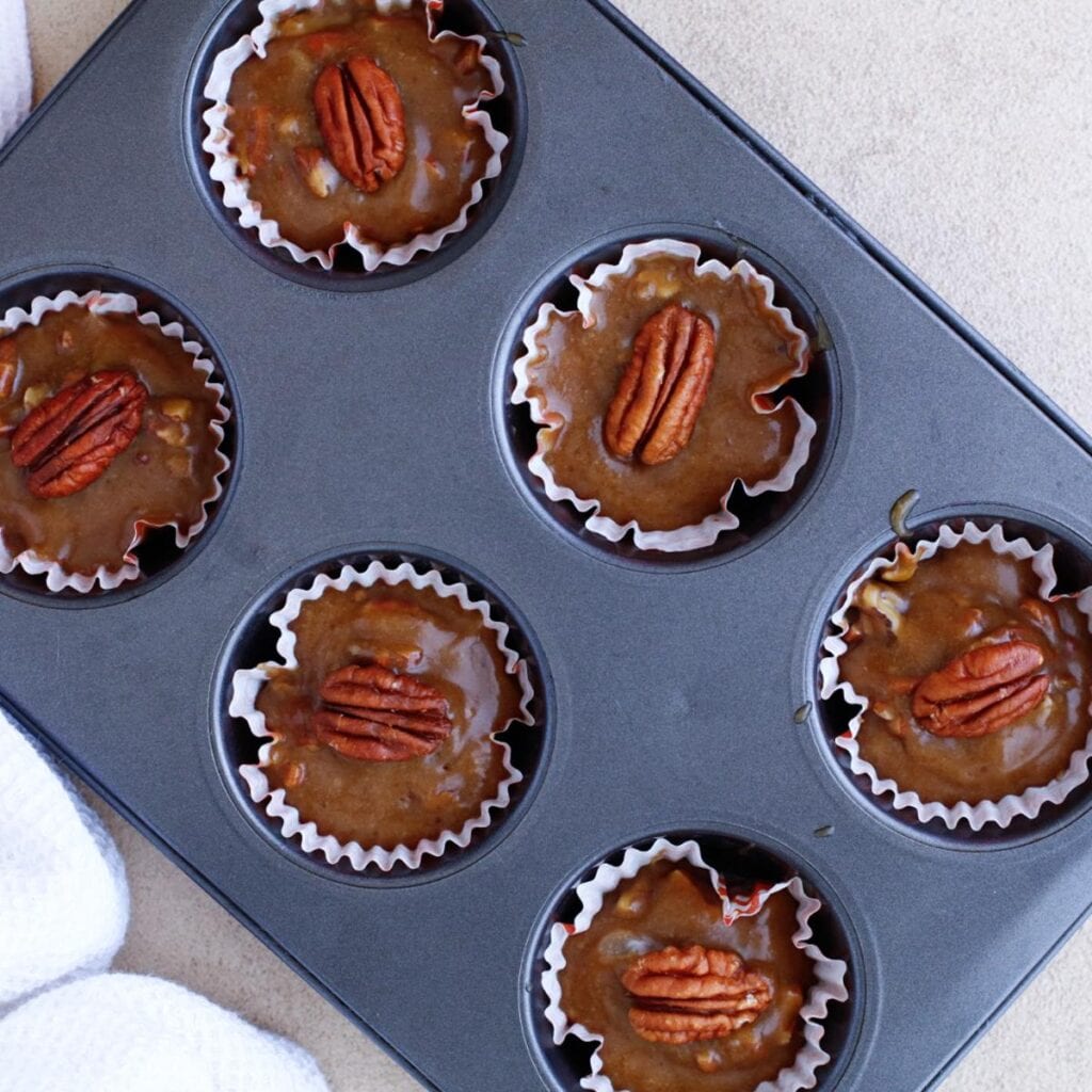 muffin tray with pecan pie mixture