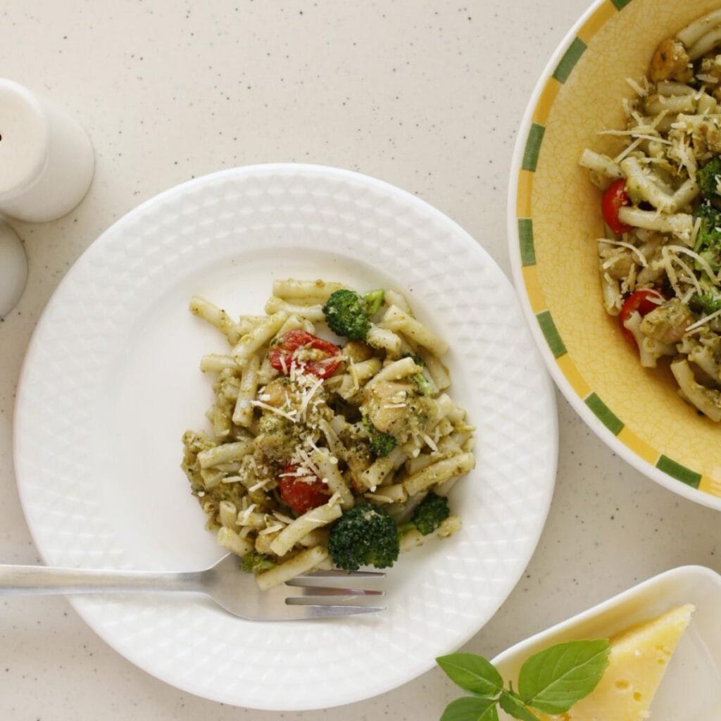 plate of pasta with veggies with cheese on top