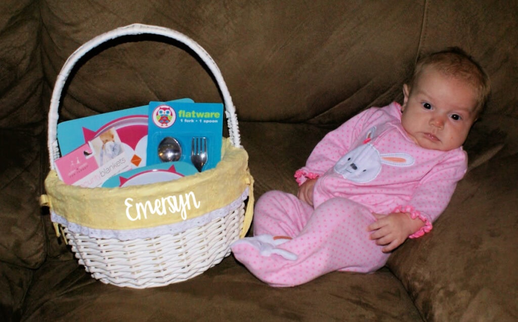 baby laying by an easter basket