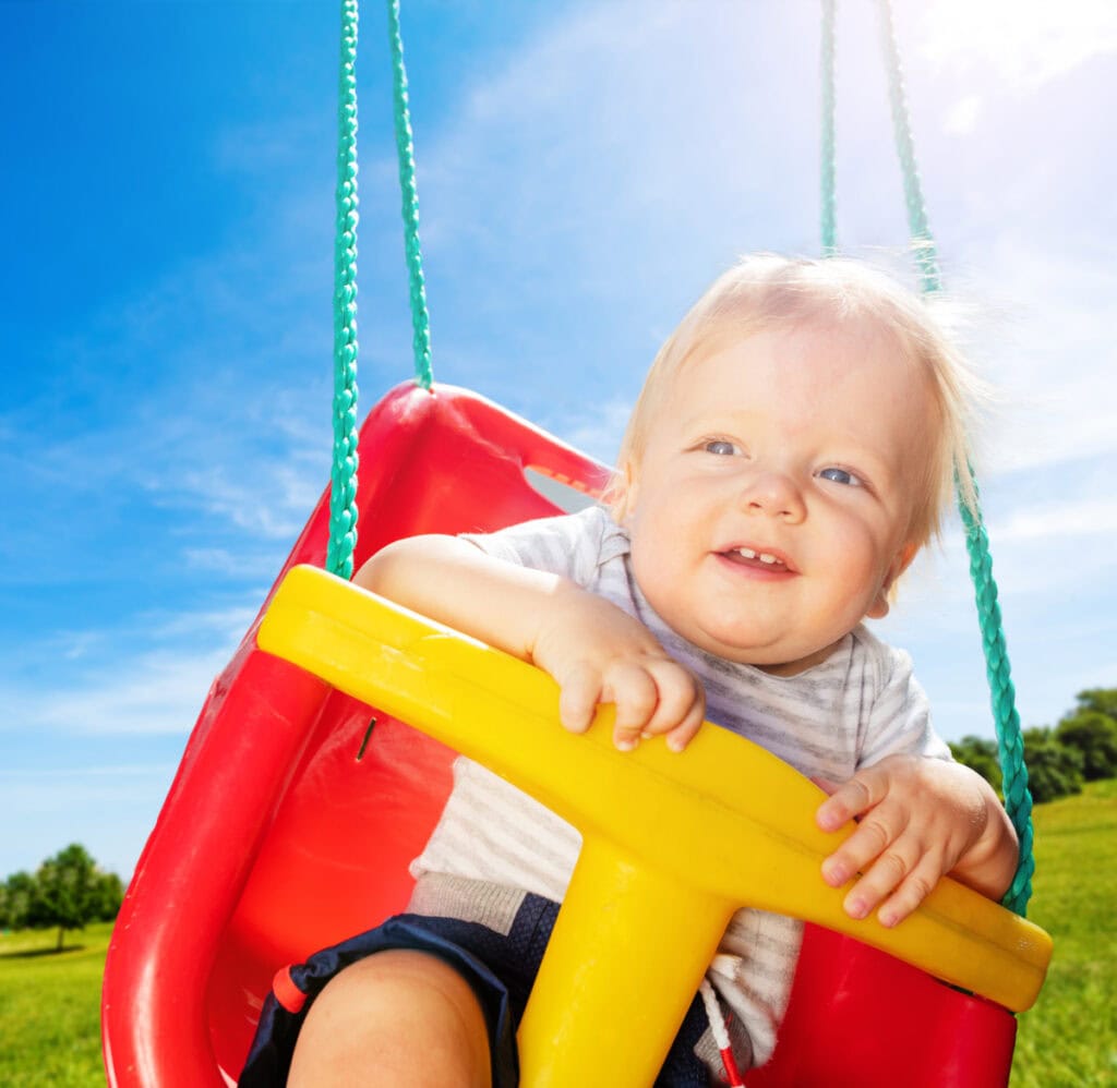 baby in outdoor baby swing