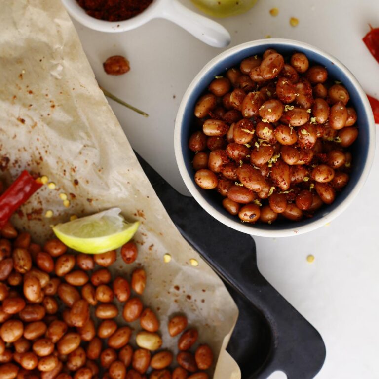 bowl of seasoned peanuts with lemon zests