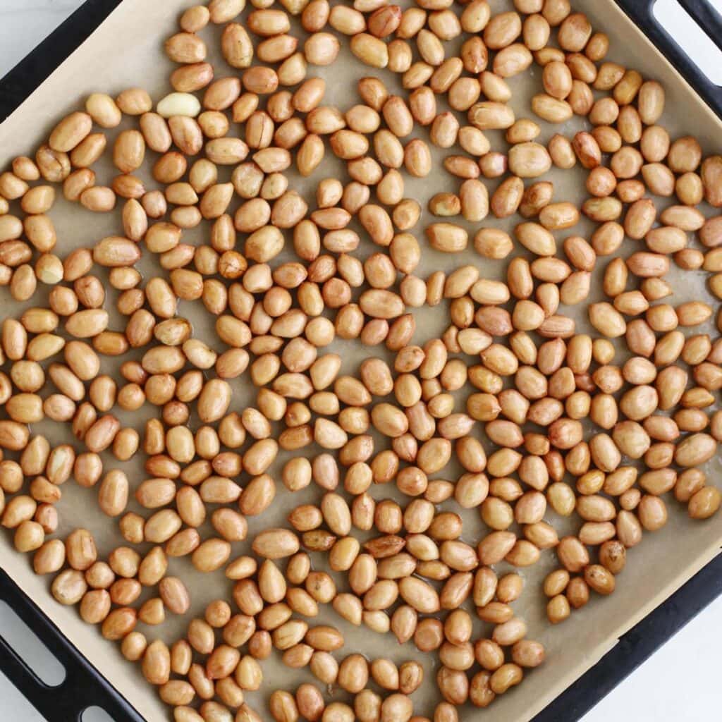 layer of peanuts on a baking pan