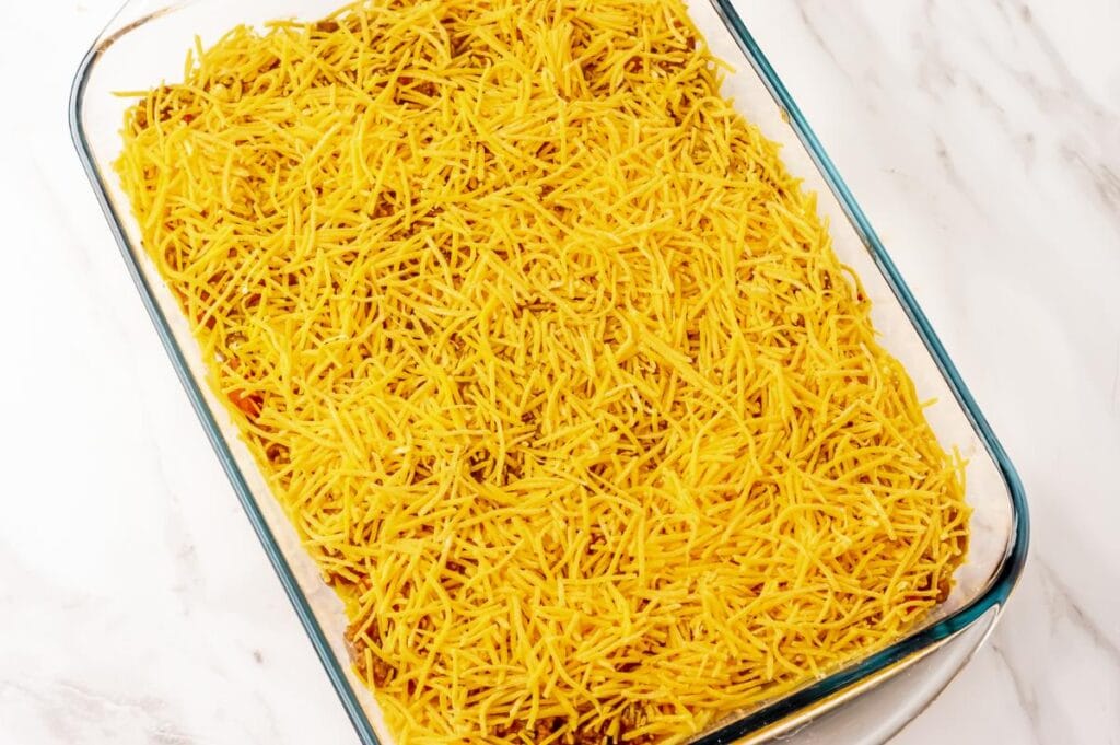 baking dish covered with shredded cheese
