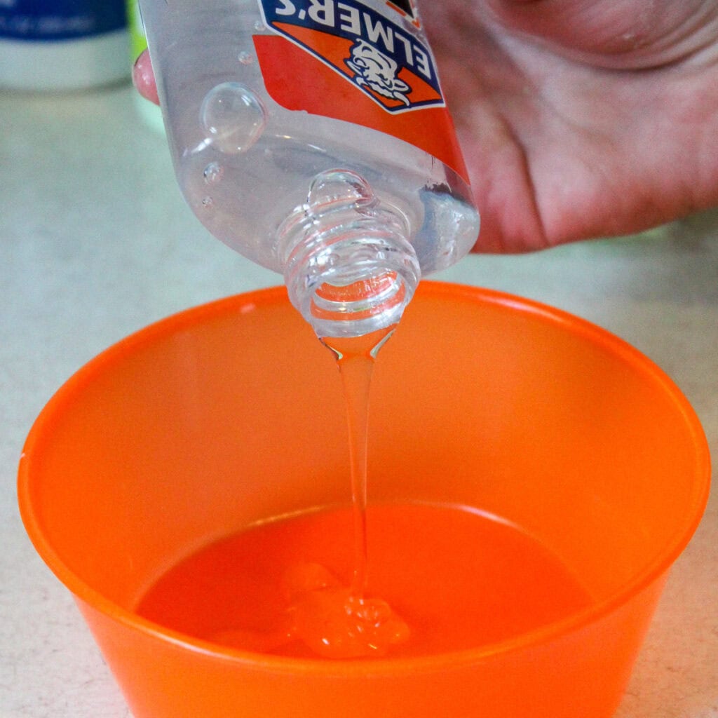 pouring entire bottle of glue in a bowl