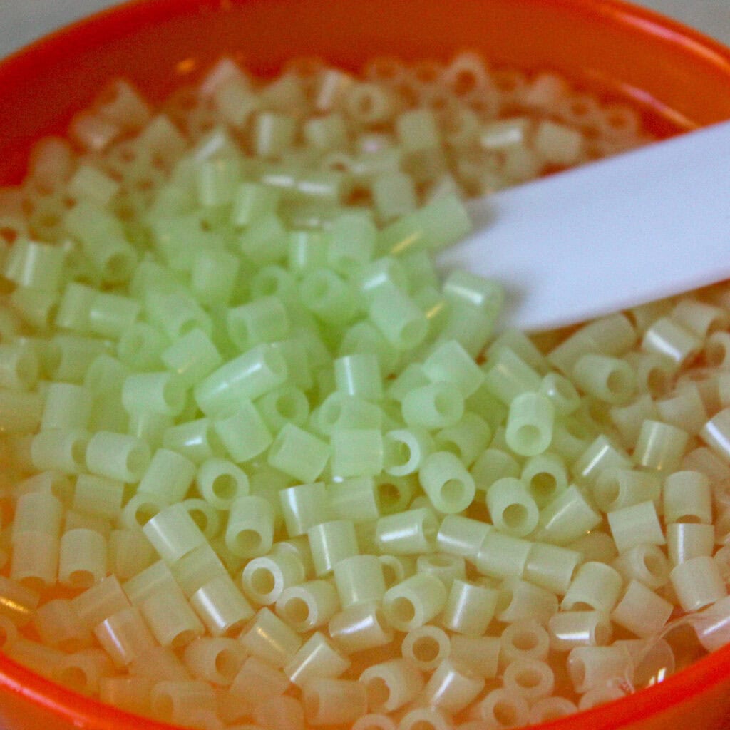 Perler Beads in a small bowl with slime mixture
