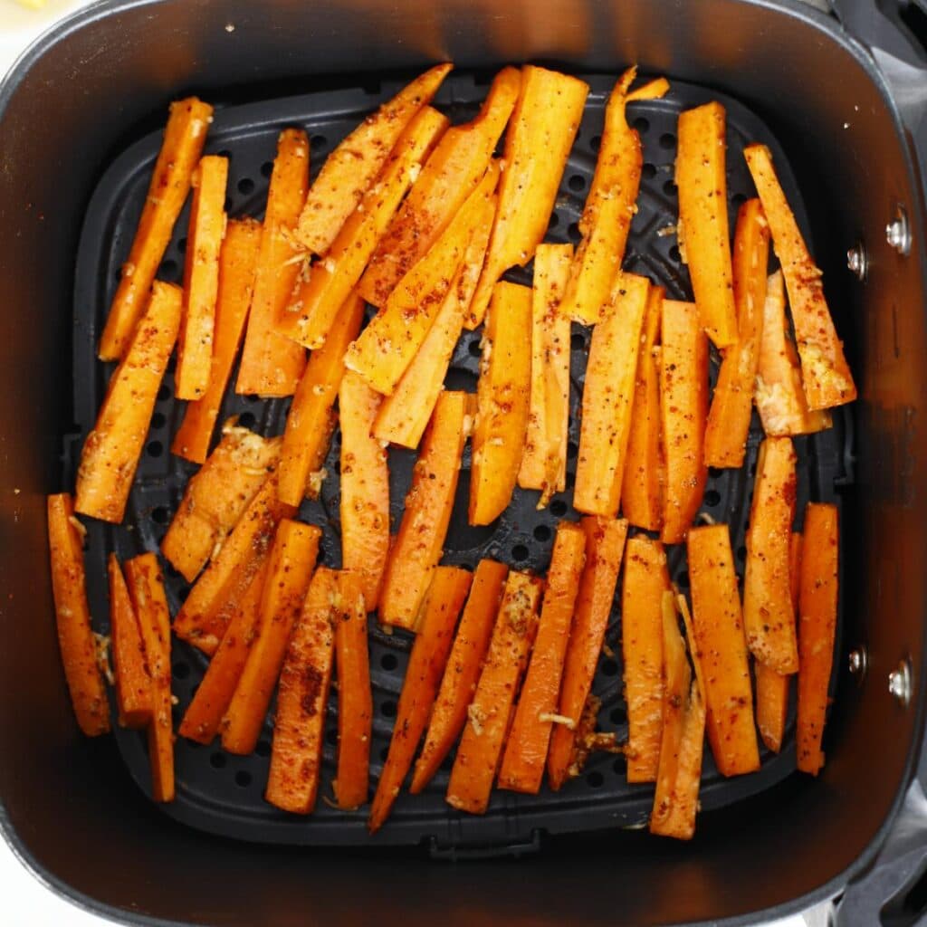 carrot strips inside an air fryer basket