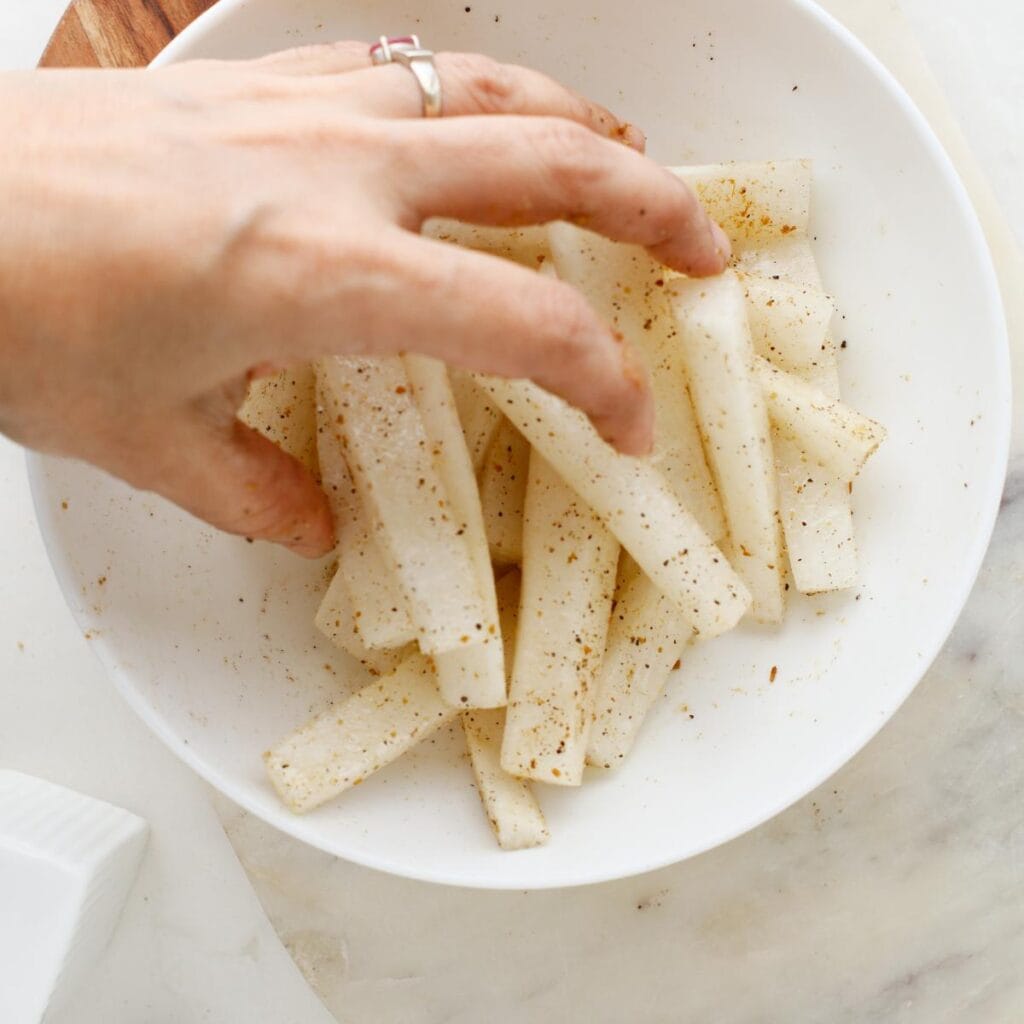 seasoning daikon radish in a bowl