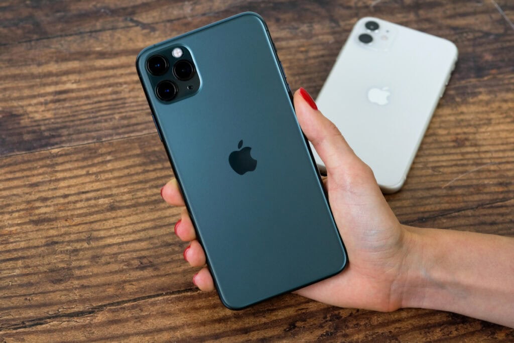 iphone on a table and in someones hand