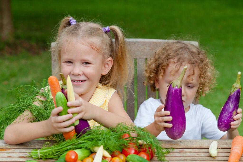 kids holding fresh vegetables