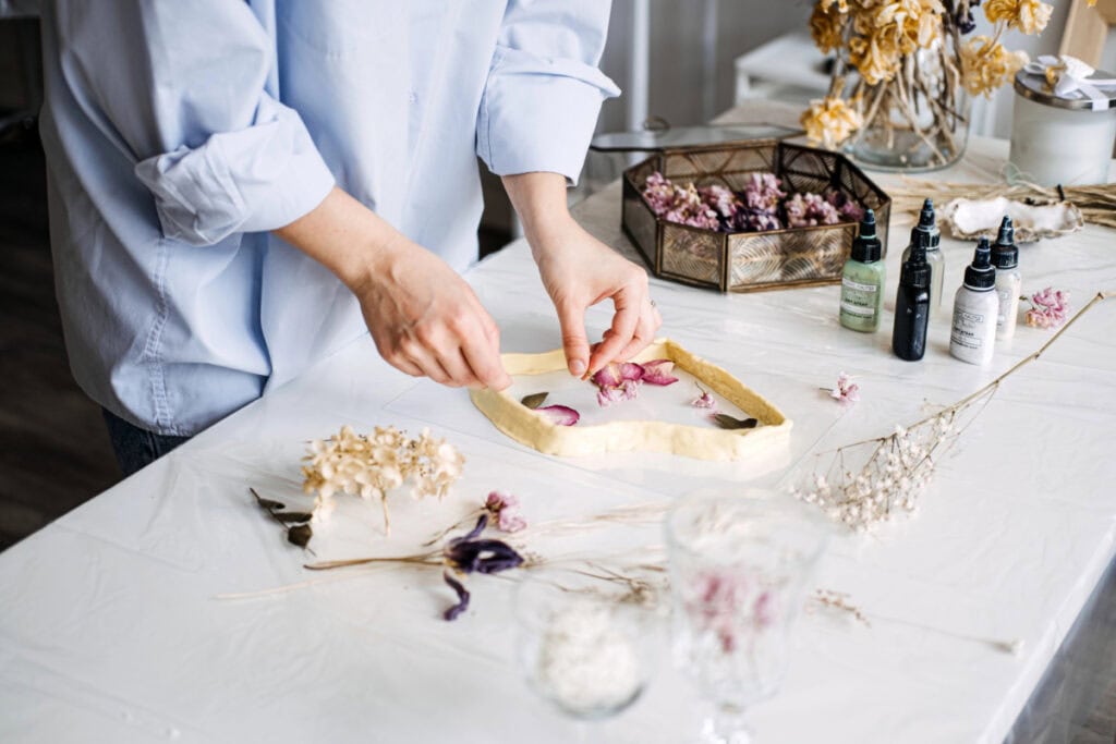 woman doing crafts with dried flowers