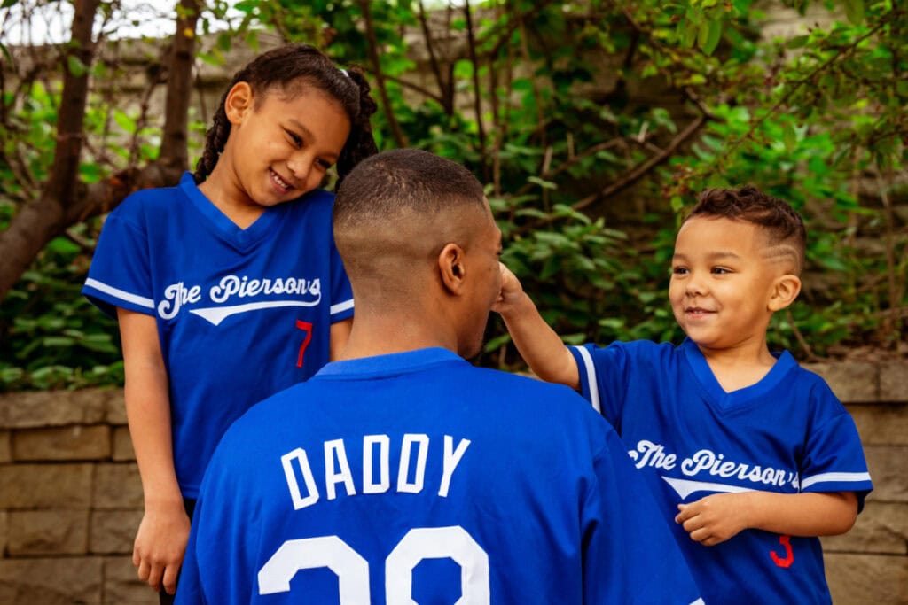 kids and father wearing custom jerseys