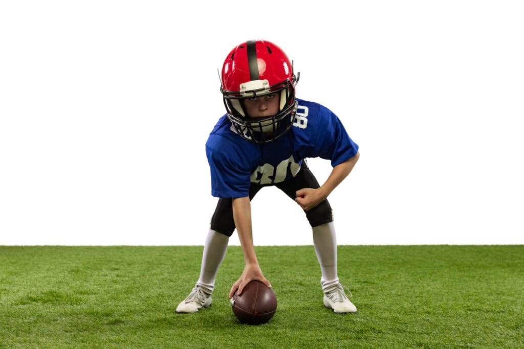 boy wearing a full football uniform