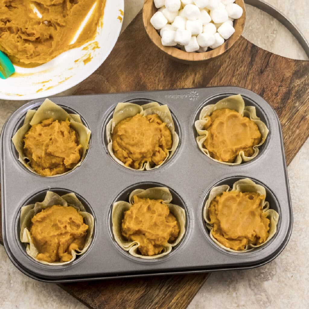sweet potato pie tarts in a tart shell, ready to bake