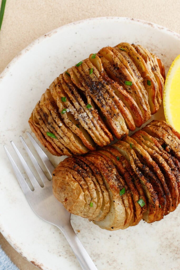 Crispy Hasselback potatoes in plate
