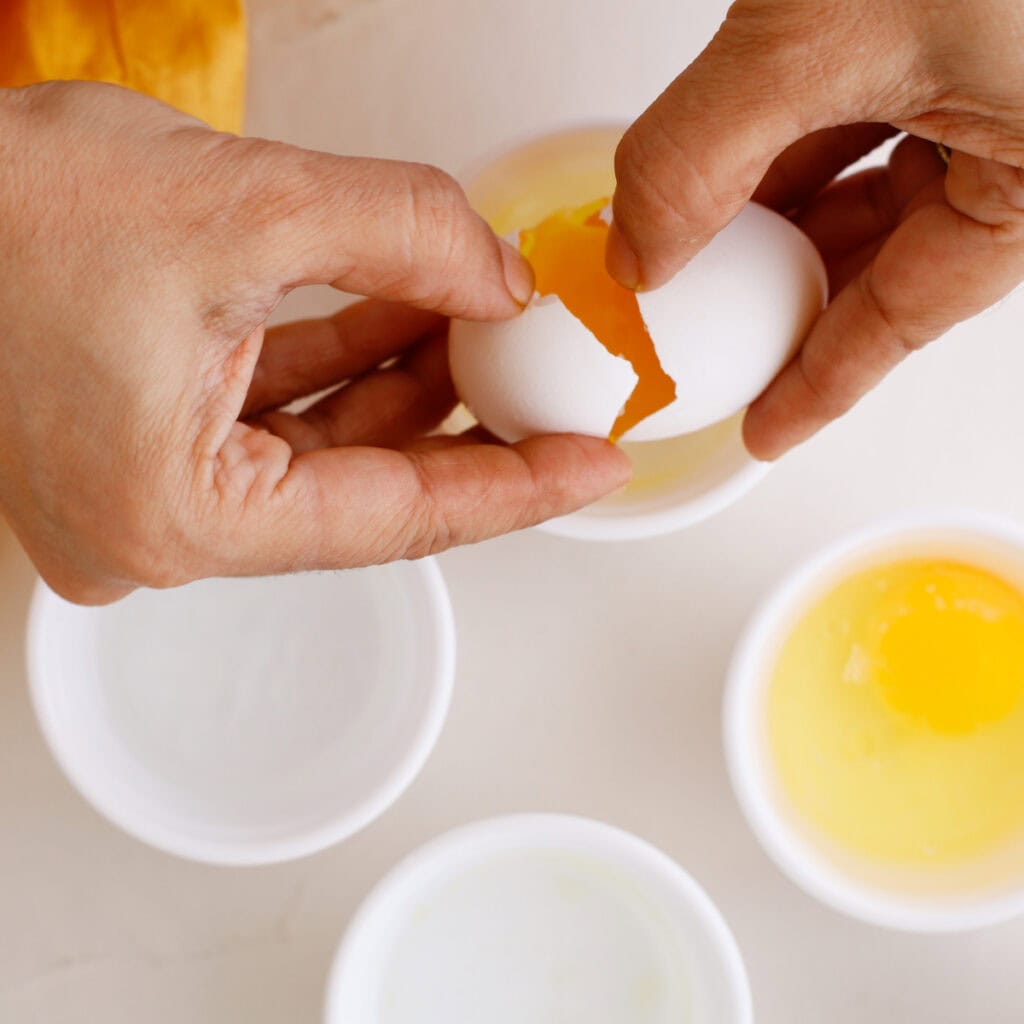 Egg cracking to prepare for poached eggs
