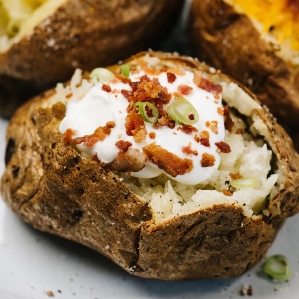 Reheated baked potato with stuffs on top