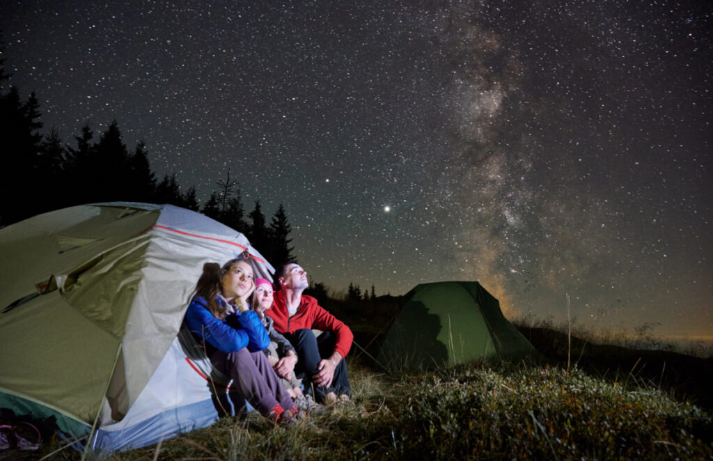 family camping out under the stars