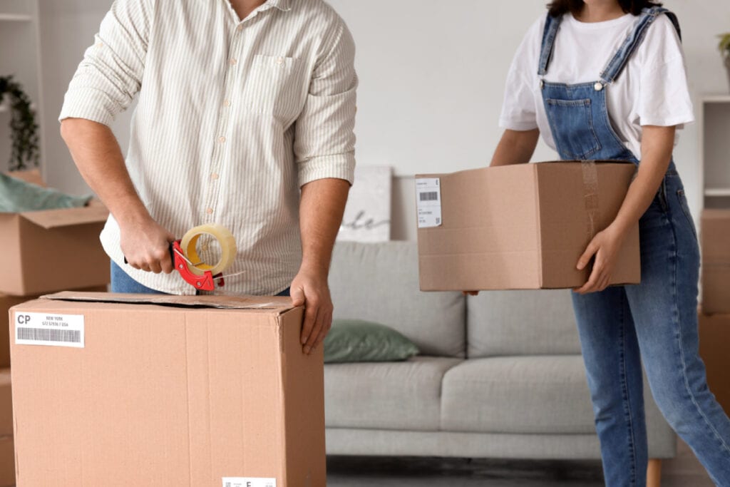 man and woman boxing up their house to move
