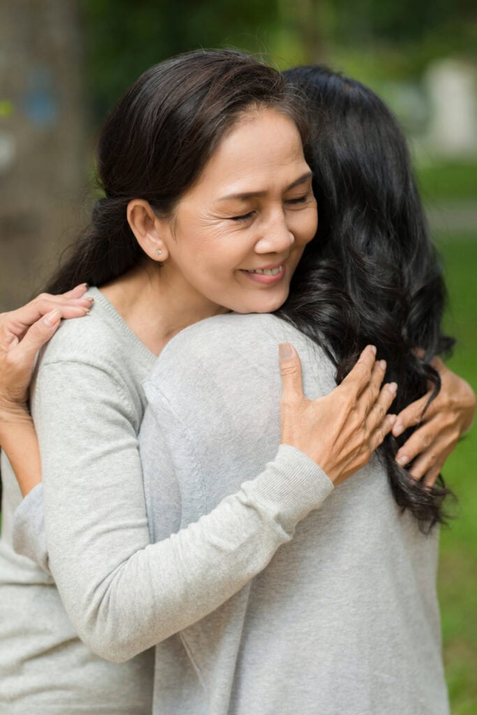 two women hugging to celebrate moments together