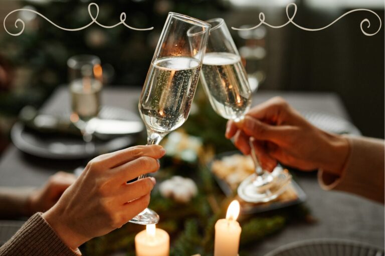 two glasses of champagne clicking in a toast