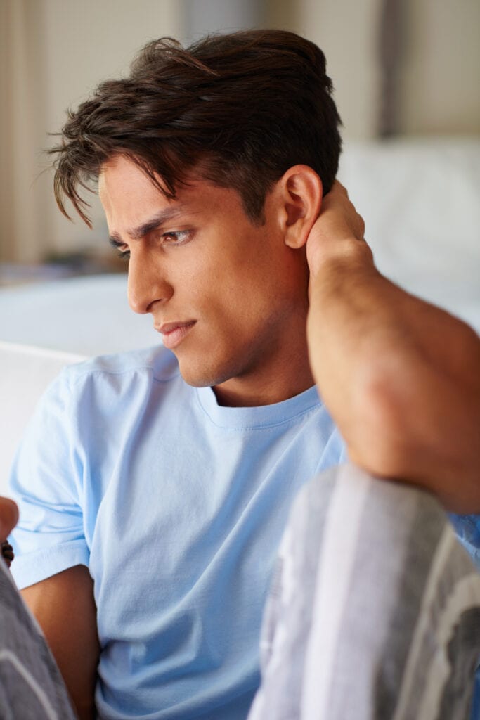 man holding back of his neck feeling stressed
