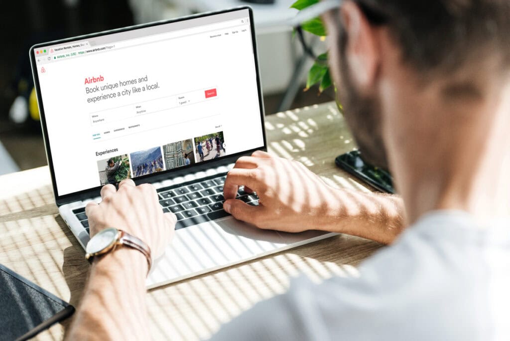 man at laptop booking on airbnb
