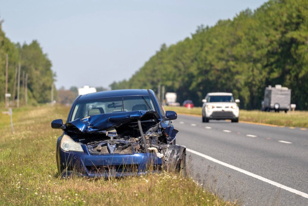 wreaked car by side of road