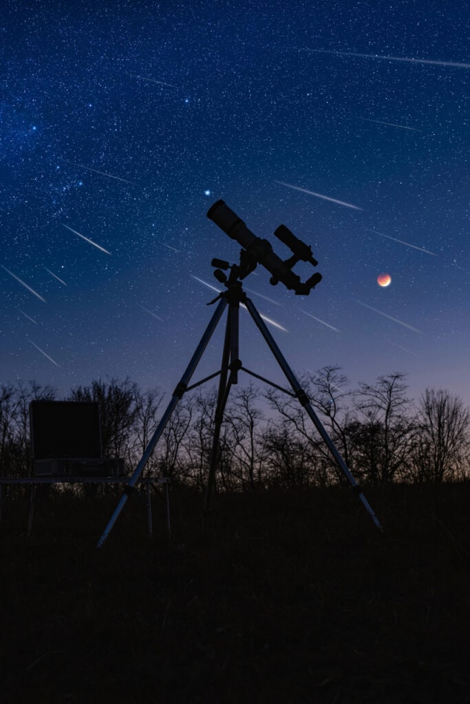 telescope and a night sky