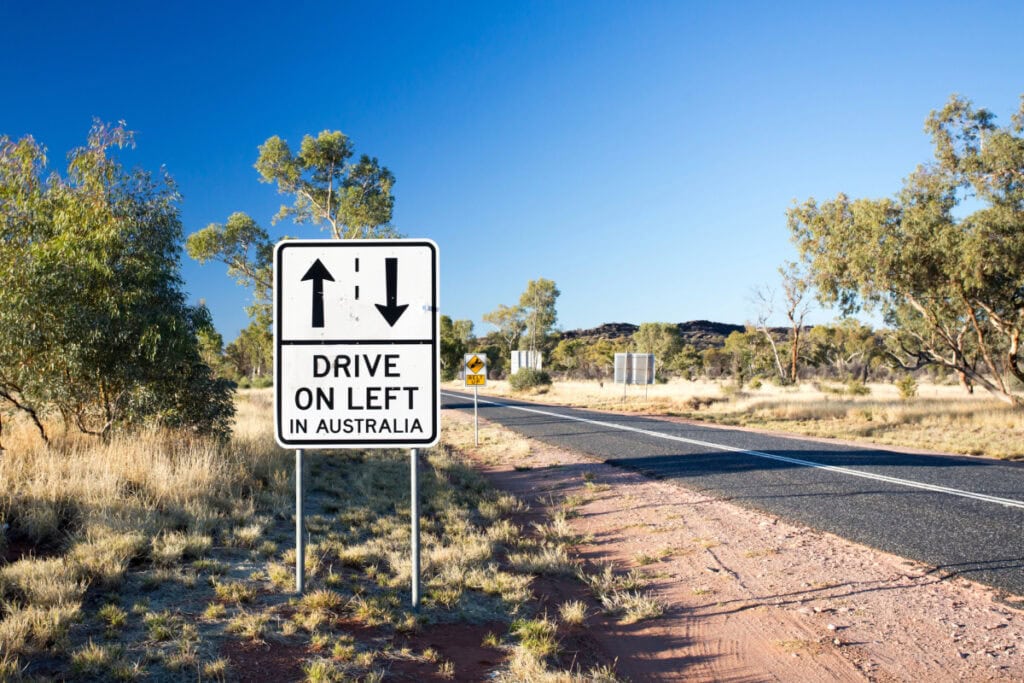 drive on left sign in Australia by a road in the country