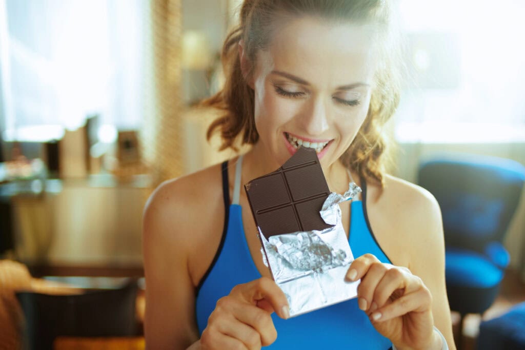 woman eating chocolate bar