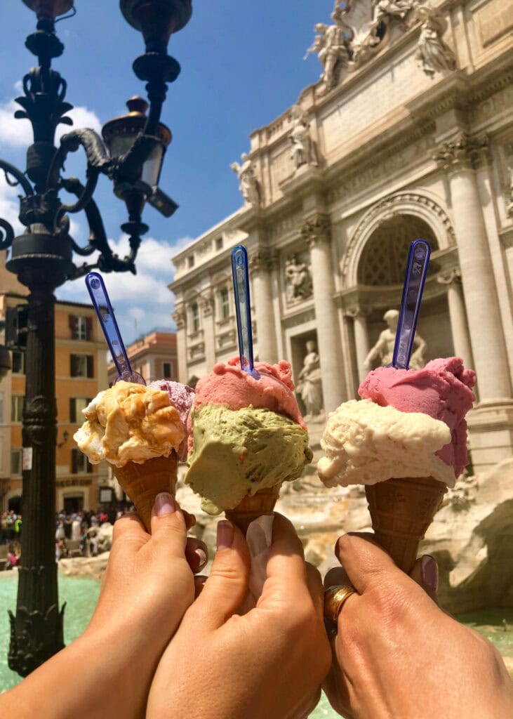 people with gelato in front of a fountain in rome